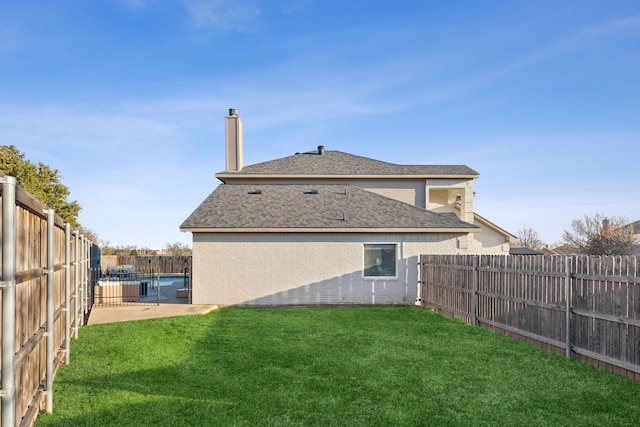 back of house featuring a yard and a patio area