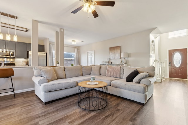 living room featuring dark hardwood / wood-style floors and ceiling fan