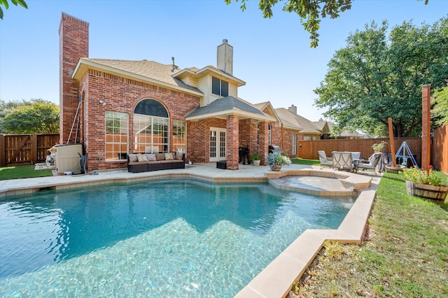 view of pool featuring an in ground hot tub, french doors, an outdoor living space, and a patio