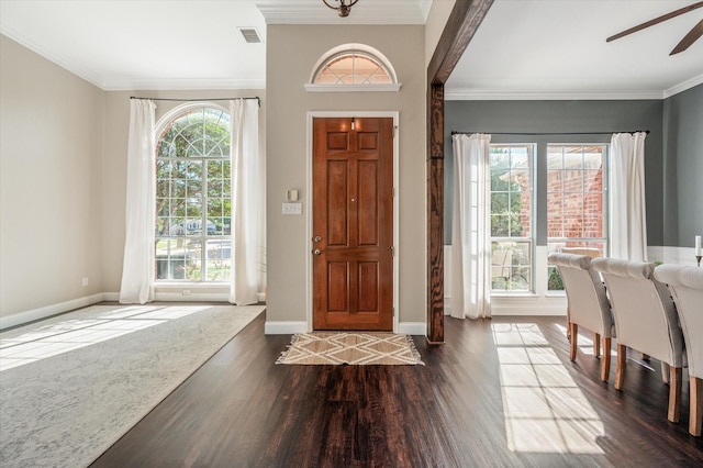 entrance foyer with dark hardwood / wood-style floors, ceiling fan, and ornamental molding