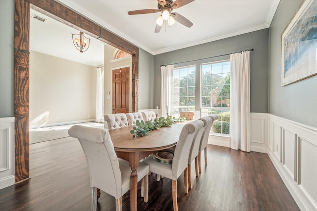 dining area featuring ceiling fan with notable chandelier, dark hardwood / wood-style floors, and crown molding