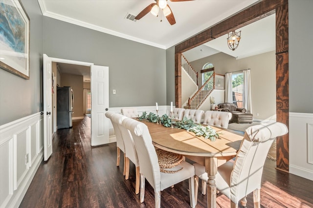 dining area featuring ceiling fan with notable chandelier, dark hardwood / wood-style floors, and crown molding