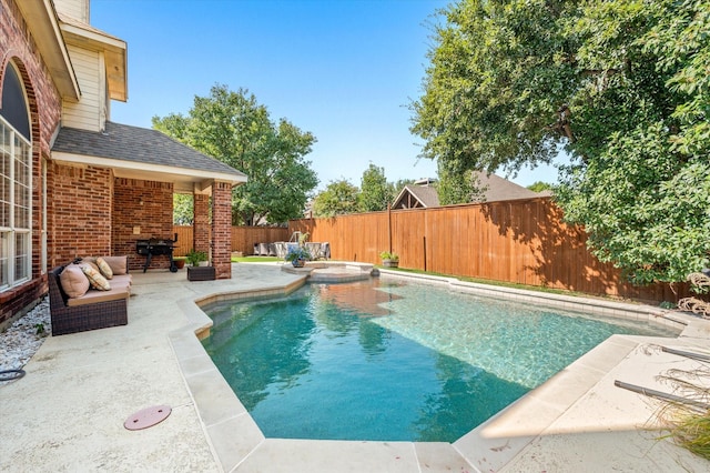 view of swimming pool featuring a patio area, area for grilling, and an outdoor hangout area