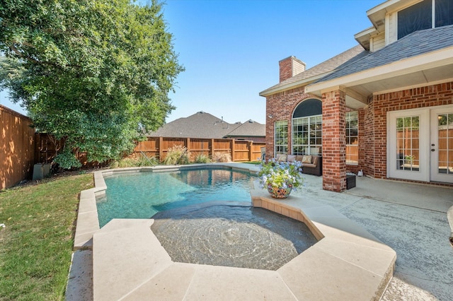 view of swimming pool featuring a patio area, outdoor lounge area, and french doors