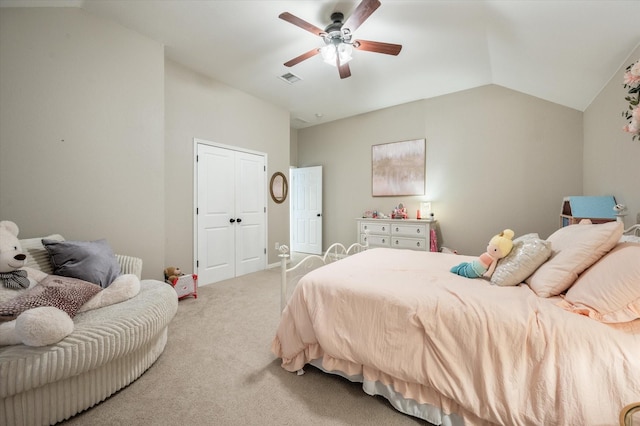 carpeted bedroom featuring ceiling fan, a closet, and vaulted ceiling