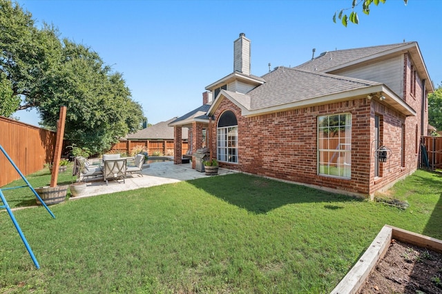 back of house featuring a yard and a patio