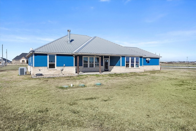 back of property featuring a lawn and cooling unit