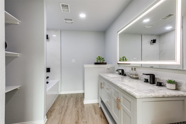 bathroom with vanity, wood-type flooring, and bathing tub / shower combination