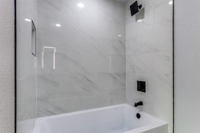 bathroom featuring tiled shower / bath