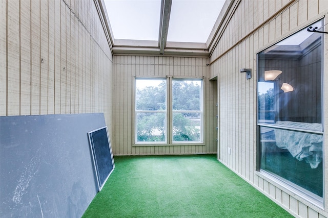 unfurnished sunroom with a skylight