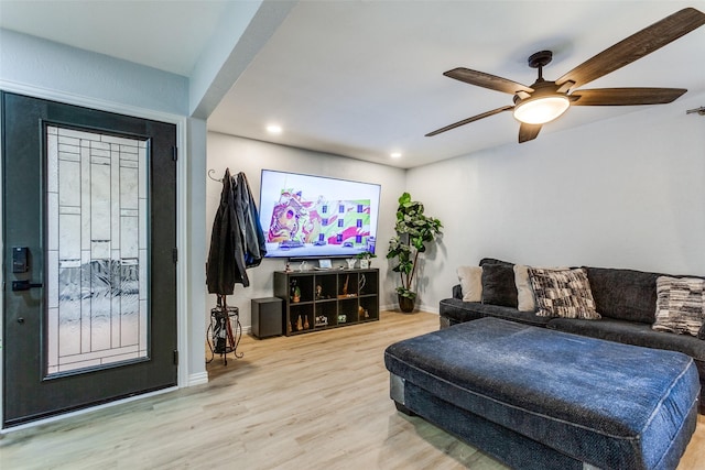 living room with light hardwood / wood-style floors and ceiling fan