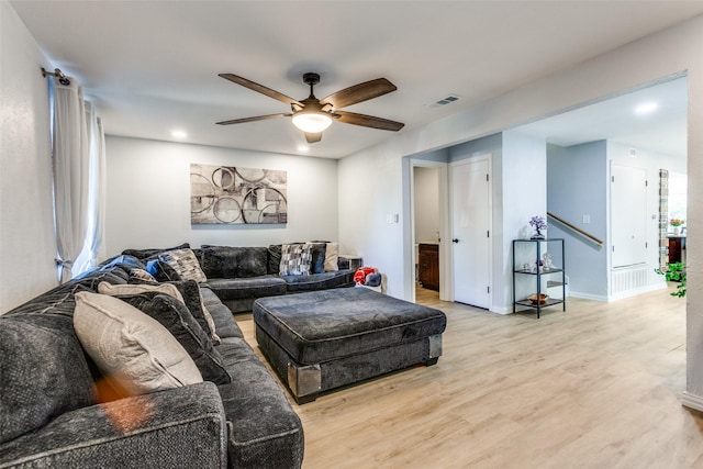 living room with light hardwood / wood-style flooring and ceiling fan