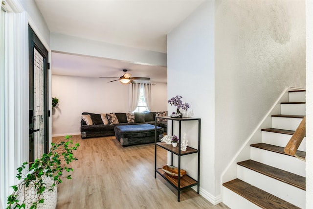 living room with ceiling fan and light hardwood / wood-style floors