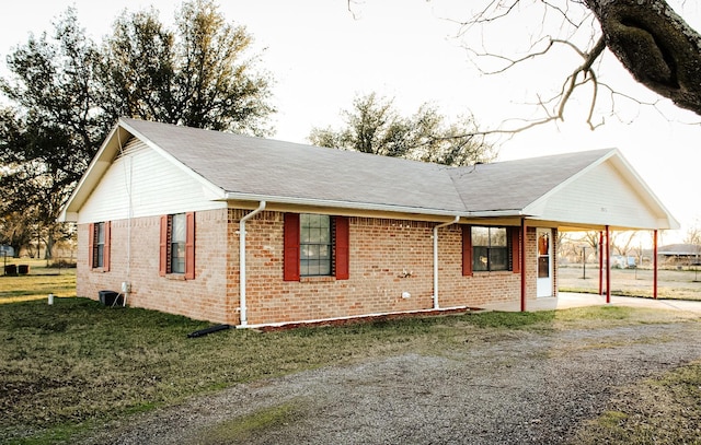 view of property exterior featuring a carport and a yard