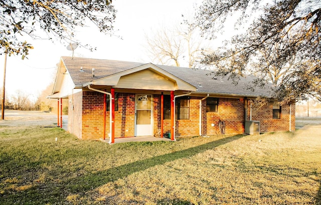 rear view of property featuring a yard