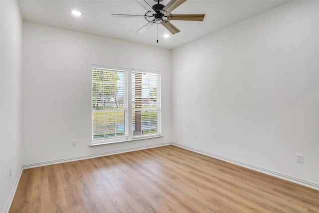 empty room with ceiling fan and light wood-type flooring