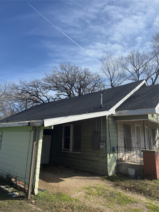 view of side of property featuring covered porch