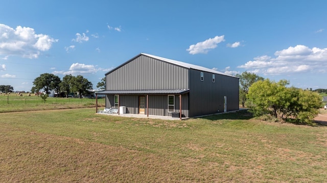 rear view of property with a lawn