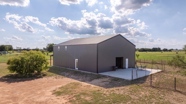 view of outdoor structure with a rural view