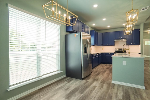 kitchen featuring dark hardwood / wood-style flooring, stainless steel fridge with ice dispenser, blue cabinetry, and a kitchen island with sink