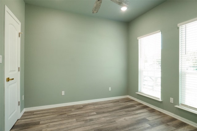 spare room with hardwood / wood-style flooring, plenty of natural light, and ceiling fan