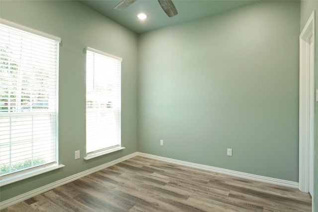 unfurnished room with hardwood / wood-style flooring and ceiling fan