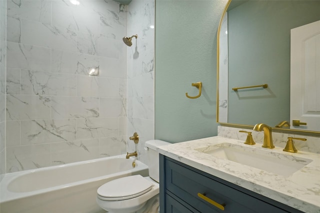 full bathroom featuring vanity, toilet, and tiled shower / bath