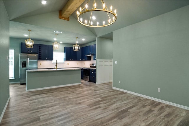 kitchen with sink, vaulted ceiling with beams, blue cabinetry, an island with sink, and stainless steel appliances