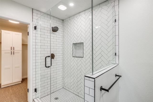 bathroom with a shower with shower door