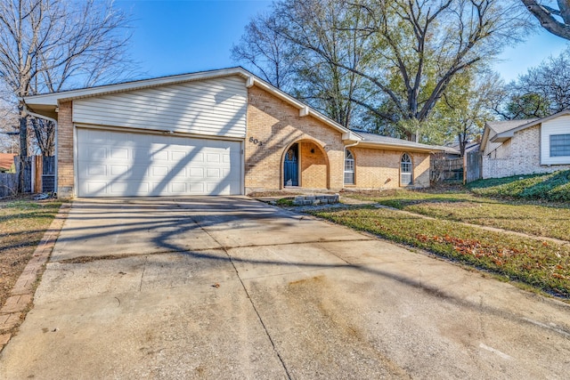 view of front of property with a front yard and a garage