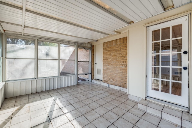 unfurnished sunroom with beamed ceiling