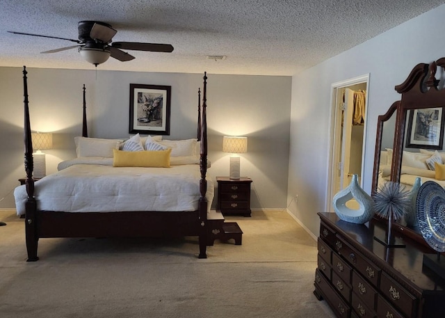 carpeted bedroom with a textured ceiling and ceiling fan