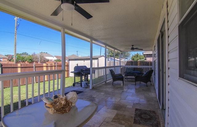 view of patio with grilling area, ceiling fan, and a storage shed