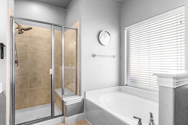 bathroom featuring tile patterned flooring and plus walk in shower