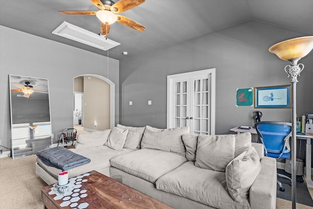 living room featuring ceiling fan, carpet floors, and vaulted ceiling