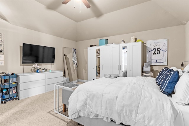 carpeted bedroom featuring ceiling fan and vaulted ceiling