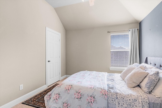 carpeted bedroom featuring vaulted ceiling