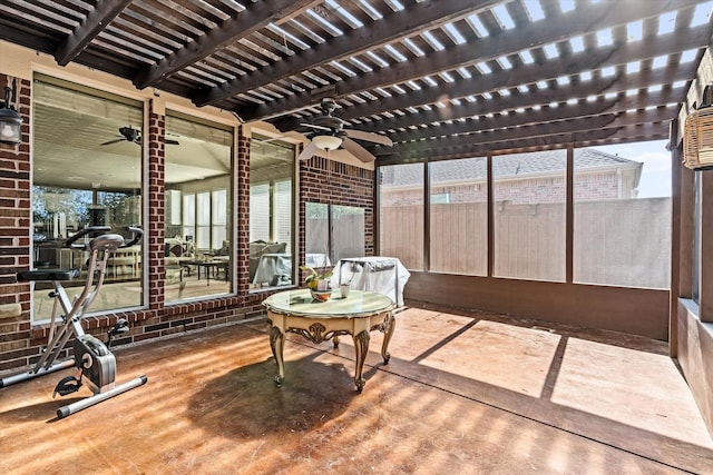 sunroom / solarium featuring beam ceiling and ceiling fan