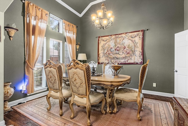 dining room featuring a notable chandelier, wood-type flooring, crown molding, and vaulted ceiling