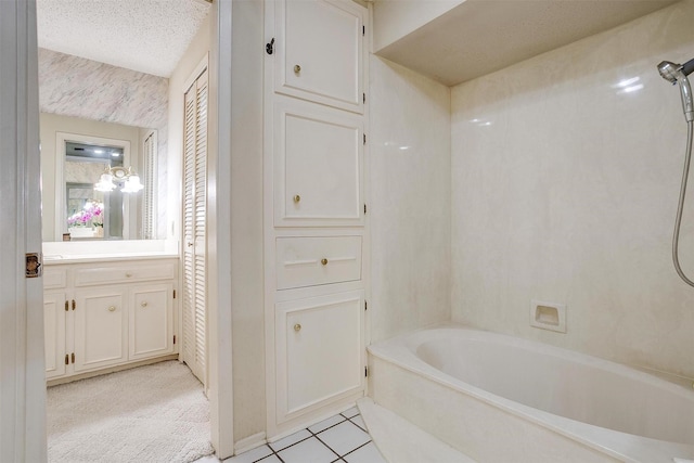 bathroom with tile patterned floors, vanity, washtub / shower combination, and a textured ceiling