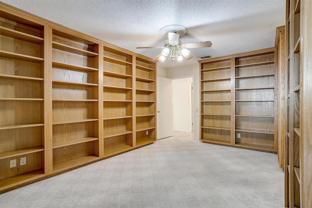 interior space with ceiling fan and a textured ceiling