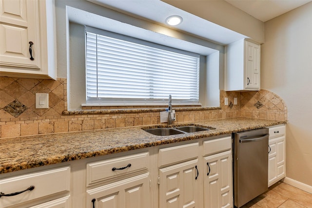 kitchen featuring backsplash, sink, white cabinets, and stainless steel dishwasher