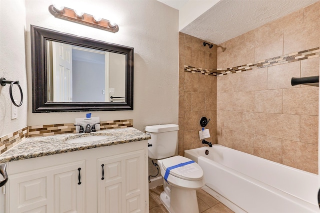 full bathroom with vanity, tiled shower / bath combo, toilet, a textured ceiling, and tasteful backsplash