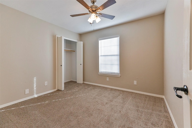 unfurnished bedroom featuring light colored carpet and ceiling fan