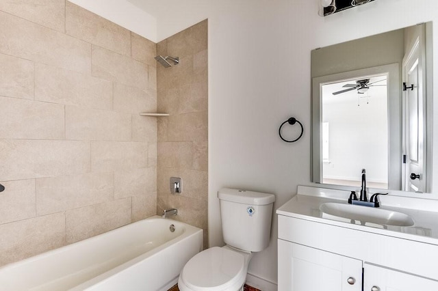 full bathroom with vanity, toilet, tiled shower / bath, and ceiling fan