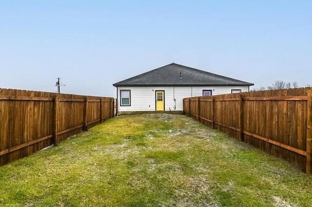 rear view of property with a lawn