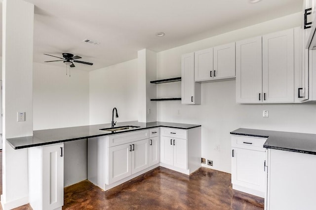 kitchen featuring white cabinets, ceiling fan, and sink