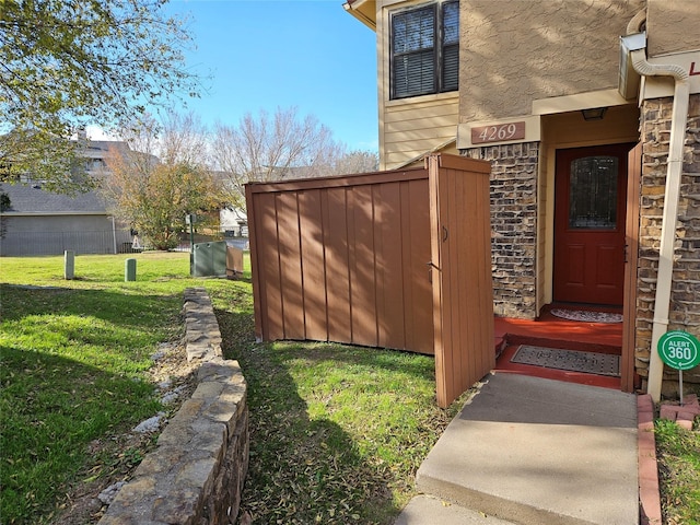 doorway to property featuring a lawn