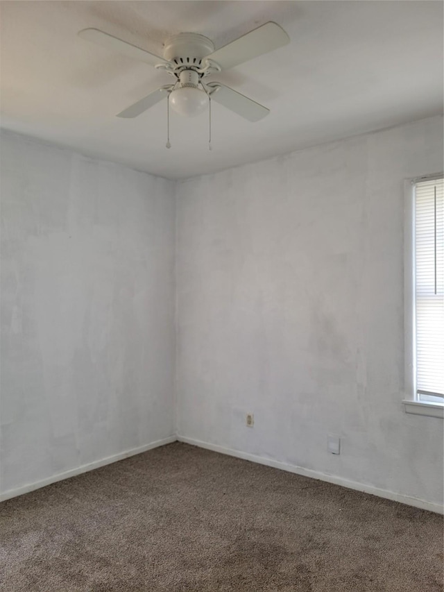 empty room featuring ceiling fan and carpet