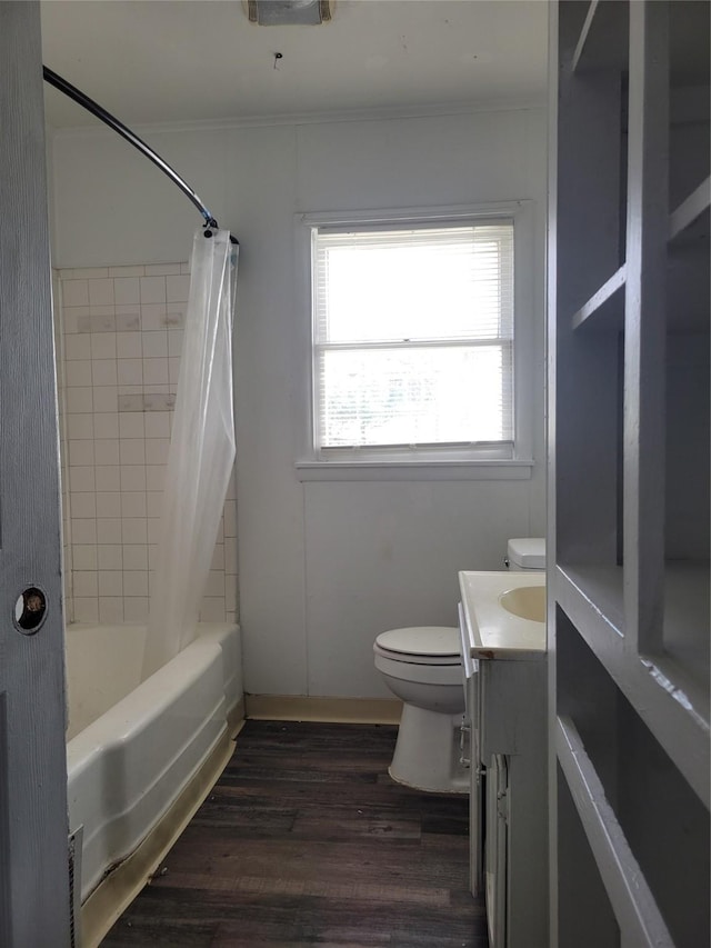 full bathroom with hardwood / wood-style floors, vanity, toilet, crown molding, and shower / bath combo with shower curtain